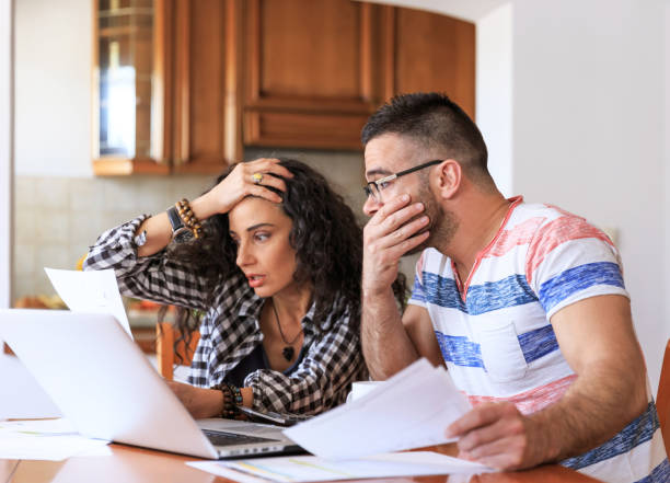 istock Couple receiving home bills 882856956