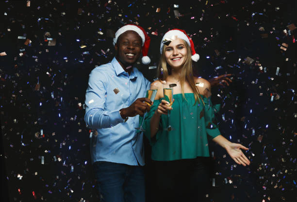 istock Joyful couple congratulating on christmas with champagne at blac 882856962