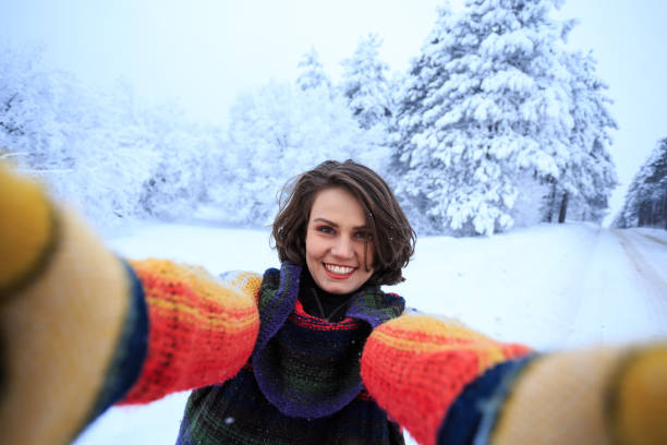 istock Young woman with multicolored scarf having fun in snow mountain 882856990