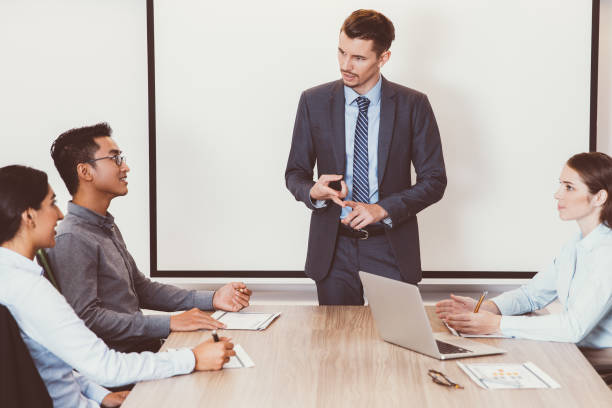 istock Serious businessman holding meeting with team 882860898