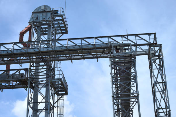 istock Fragment of metal grain elevator in facility with silos. 882866014