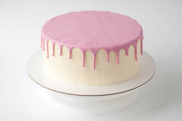 istock Baking cake, decorated with pink glaze on a white background. 882866234