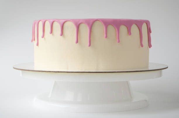 istock Baking cake, decorated with pink glaze on a white background. 882866238