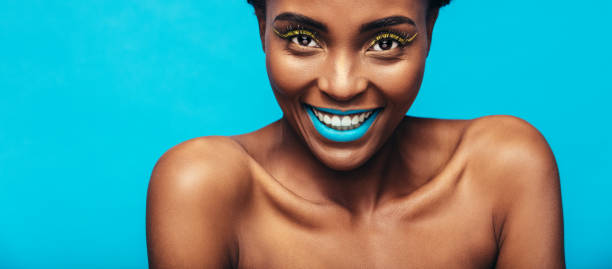 istock Beautiful smiling woman with vibrant makeup 882871774