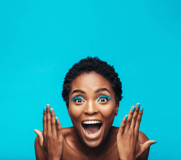 istock Excited young woman with vibrant makeup 882874166