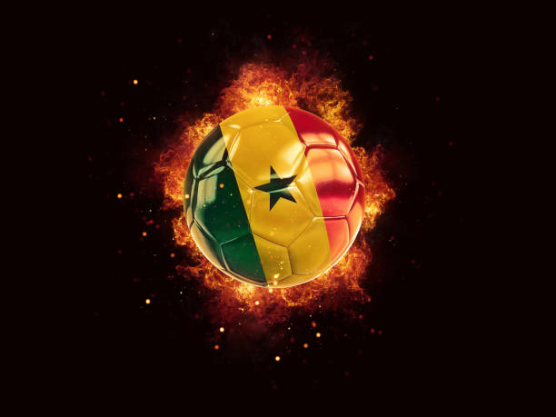 Football in flames with flag of senegal stock photo