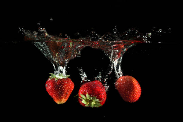 istock Strawberries splashing into water 882881788