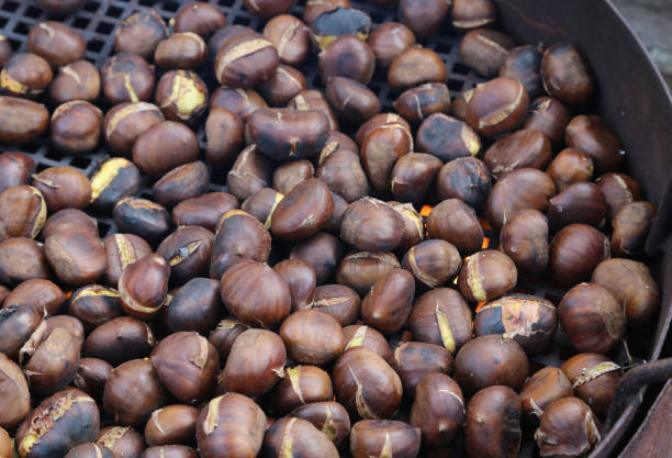 istock Roasted chestnuts on the grate with the fire the typical autumn 882881882