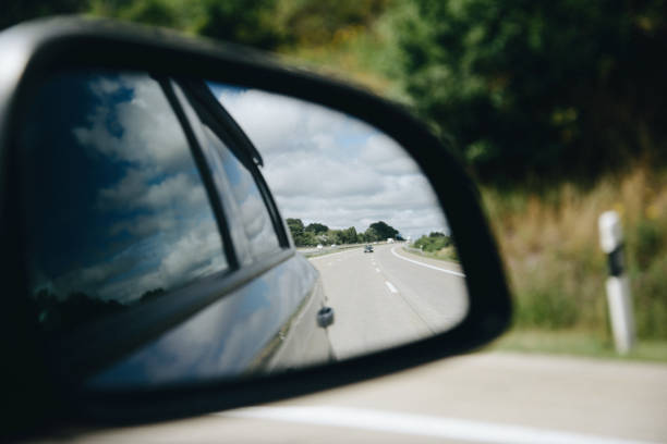 istock Reflection of asphalt highway road at the car side mirrow 882882462