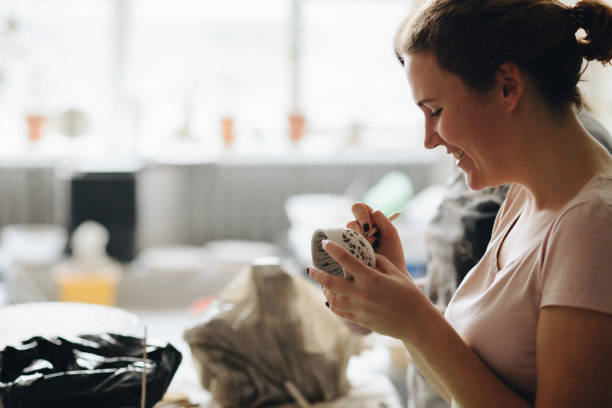 istock Female maker ceramics creating a shape of ceramic object 882882464