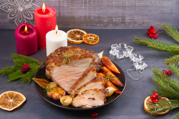 istock Roasted Christmas ham on black plate and festive decoration 882882476