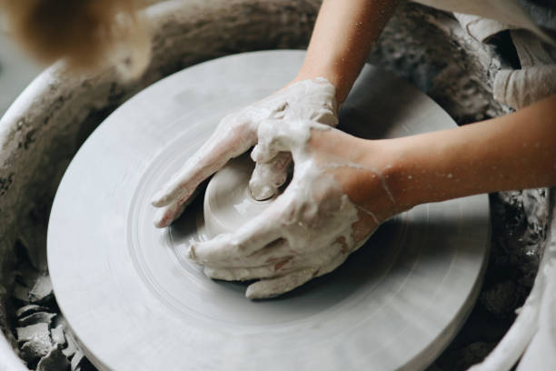 istock Female maker ceramics working with pottery wheel 882885034
