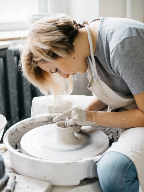istock Female maker ceramics working with pottery wheel 882885122