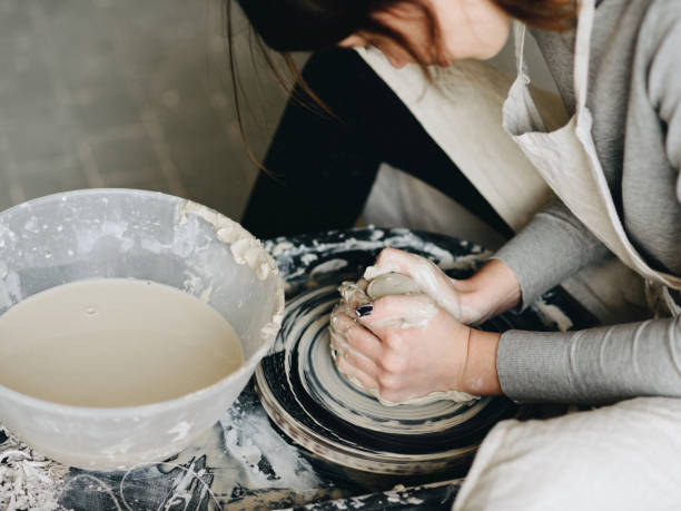 istock Female maker ceramics working with pottery wheel 882885348