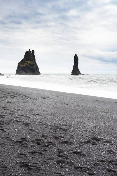 istock Reynisdrangar basalt stacks on Reynisfjara Beach 882885384