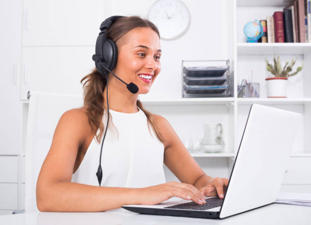 istock young woman with head set at office 882885806