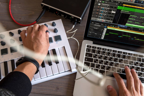 Musician is recording tunes on his computer music. first-person view Musician is recording tunes on his computer music making music stock pictures, royalty-free photos & images