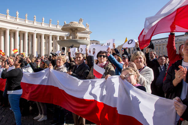 Pilgrims with Polish flag during Urbis et Orbis prayer on Sunday Vatican, November 19, 2017: Pilgrims with Polish flag during Urbis et Orbis prayer on Sunday at Saint Peters Square. orbis stock pictures, royalty-free photos & images
