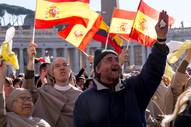 Pilgrims during Urbis et Orbis prayer Vatican, November 19, 2017: pilgrims with Spanish flag during Urbis et Orbis prayer on Sunday at Saint Peters Square. orbis stock pictures, royalty-free photos & images