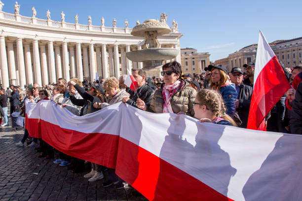 Pilgrims with Polish flag during Urbis et Orbis prayer on Sunday Vatican, November 19, 2017: Pilgrims with Polish flag during Urbis et Orbis prayer on Sunday at Saint Peters Square. orbis stock pictures, royalty-free photos & images