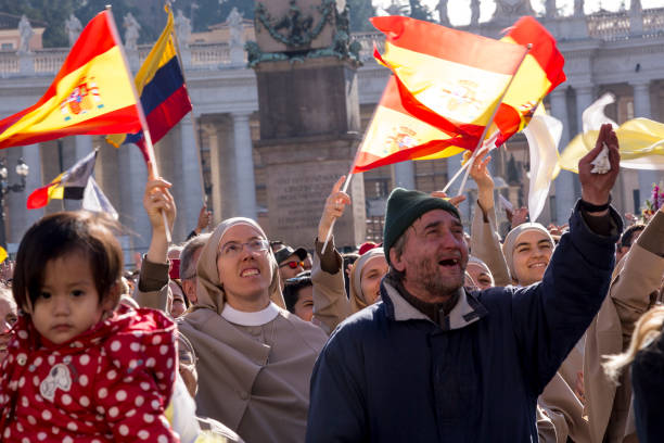 Pilgrims during Urbis et Orbis prayer Vatican, November 19, 2017: pilgrims with Spanish flag during Urbis et Orbis prayer on Sunday at Saint Peters Square. orbis stock pictures, royalty-free photos & images