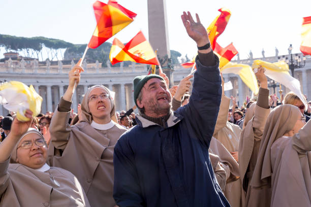 Pilgrims during Urbis et Orbis prayer Vatican, November 19, 2017: pilgrims with Spanish flag during Urbis et Orbis prayer on Sunday at Saint Peters Square. orbis stock pictures, royalty-free photos & images