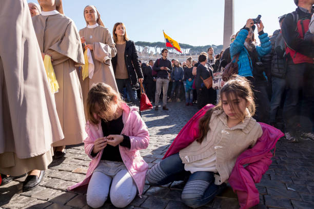 Pilgrims during Urbis et Orbis prayer Vatican, November 19, 2017: Pilgrims during Urbis et Orbis prayer on Sunday at Saint Peters Square. orbis stock pictures, royalty-free photos & images
