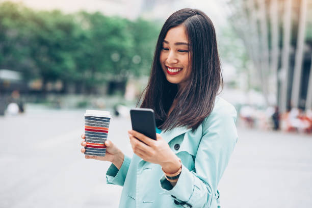 istock Japanese girl texting outdoors 882909080