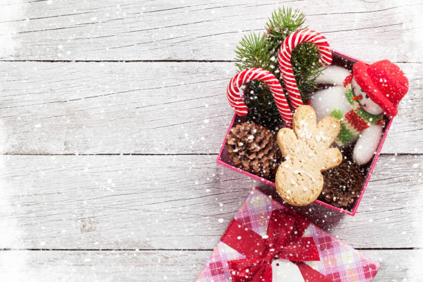 istock Christmas gift box with gingerbread man, candy canes 882921738