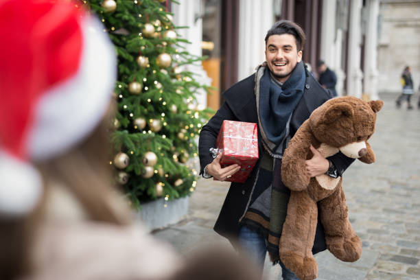 istock Handsome man giving presents for christmas to his girlfriend 882922316