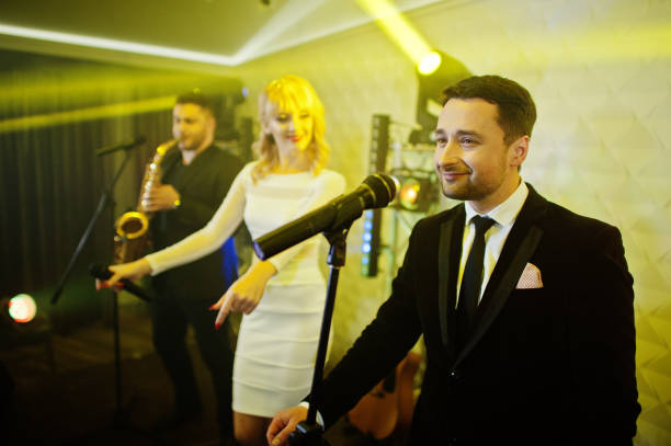 istock Musicial music live band performing on a stage with different lights. 882935280