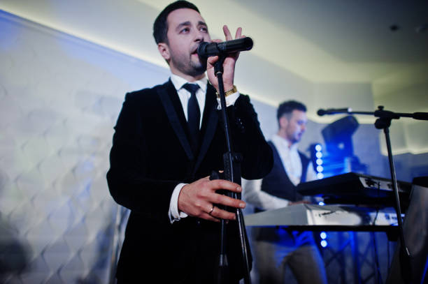 istock Musicial music live band performing on a stage with different lights. 882940098