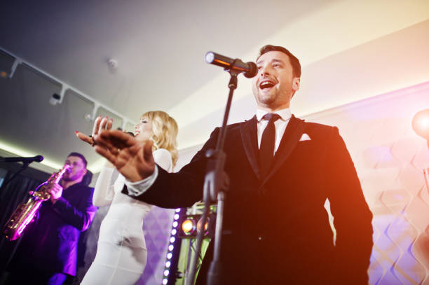 istock Musicial music live band performing on a stage with different lights. 882940346