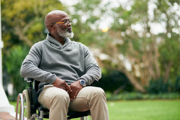 Taking in the views Cropped shot of a handsome senior man sitting in his wheelchair outside wheelchair stock pictures, royalty-free photos & images