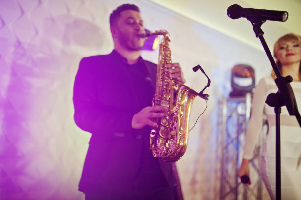 istock Musicial music live band performing on a stage with different lights. 882950186