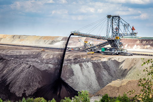 Steel giant excavator machine with conveyor bridge used in brown coal opencast mining, Belchatow, Poland