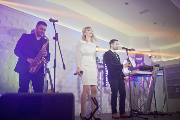 istock Musicial music live band performing on a stage with different lights. 882959340