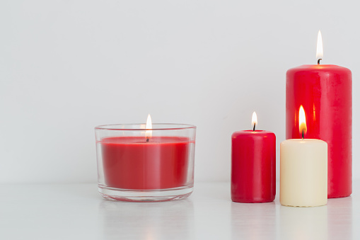 Group of Lit Church Candles, royal blue background.