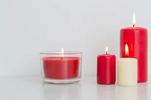 Photo of red candle on white background