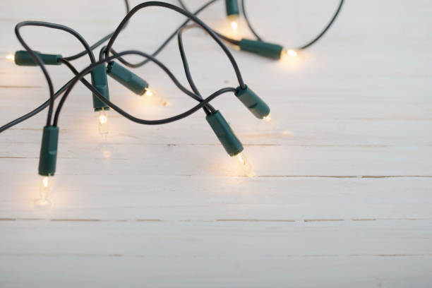 istock Christmas light on white wooden background 882959490