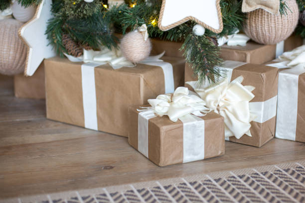 istock Many Christmas gift with a white bow of ribbons under the tree. 882959946
