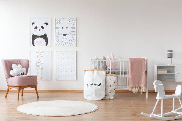 Pink armchair in child's room White rocking horse and carpet in child's room with pink armchair, paper bags, drawings and bed carpet cushion stock pictures, royalty-free photos & images