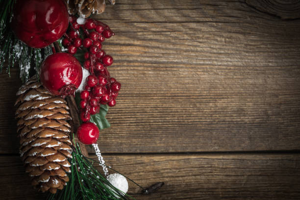 istock Christmas wooden background with cone and snow tree. 882966832