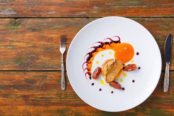 istock Roasted goose liver with date fruit and apple 882979384