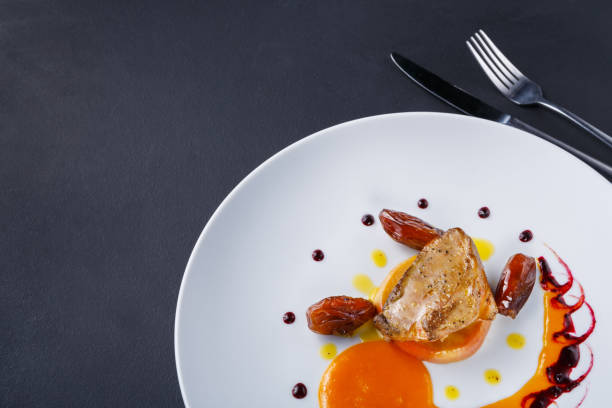 istock Roasted goose liver with date fruit and apple 882979462