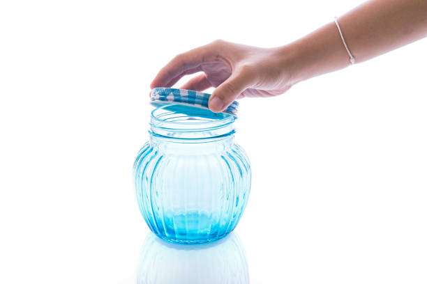 Close up of hands opening a jar.