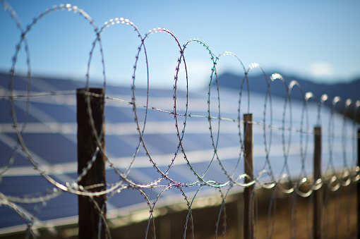 A barbwire fence in front of a solar energy plant on a farm in the Western Cape South Africa