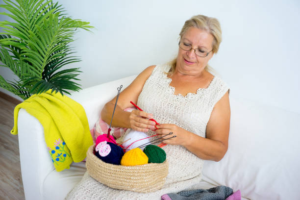 istock Grandmother knitting at home 882984470