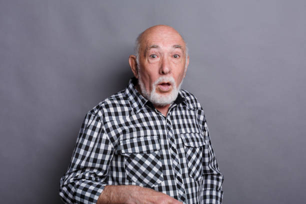 istock Surprised senior man covering mouth with hand 882987494