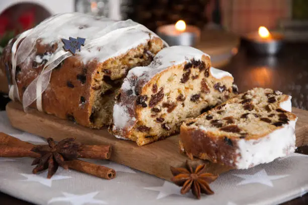 Sliced Christmas Stollen. Traditional german christmas cake with dried fruits and icing sugar.